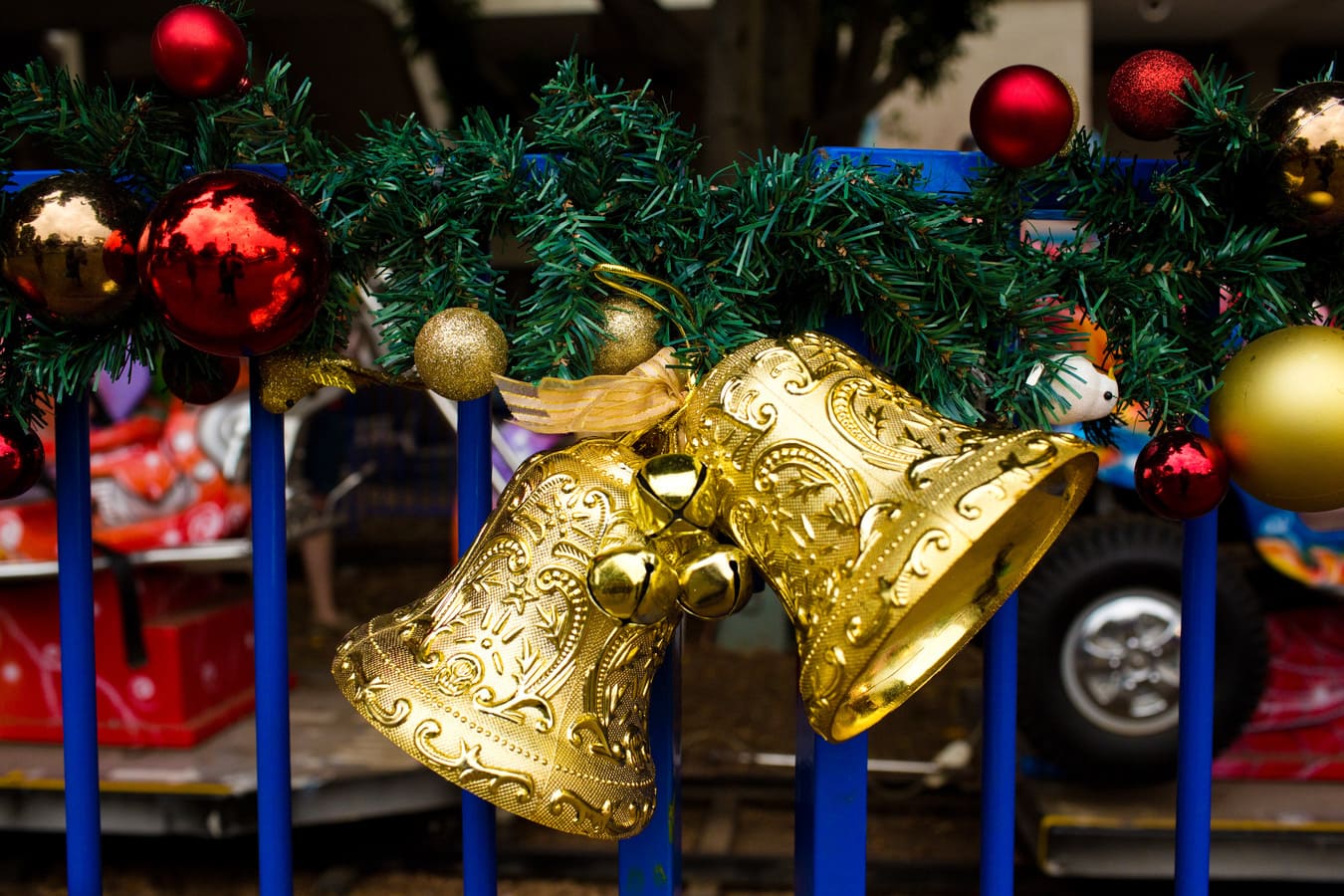 A close up of Christmas bells and baubles on a railing