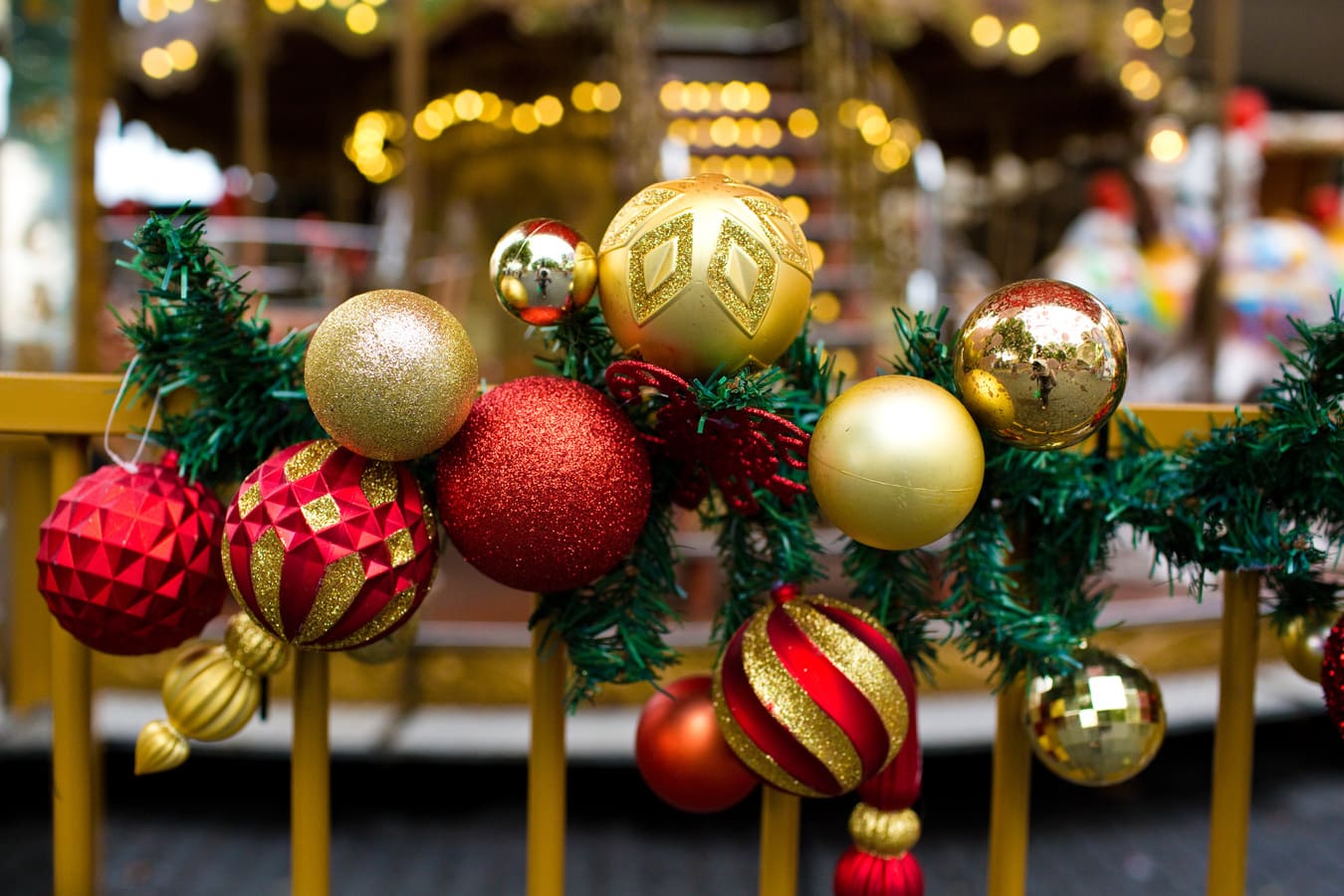 A close up of Christmas baubles on a railing