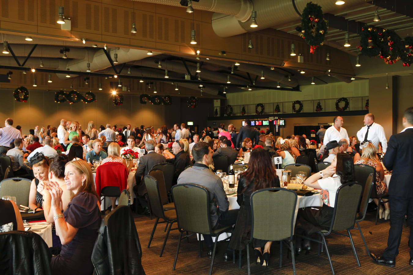 Interior of a Christmas themed function room with people sitting at tables